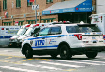 ICE Warning Escalates New York Immigration Fight Police car and ambulances outside emergency room entrance.