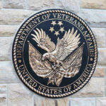 VA Tinnitus Ratings Could Be Slashed Under New Bill Department of Veterans Affairs seal on brick wall.