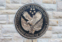 VA Tinnitus Ratings Could Be Slashed Under New Bill Department of Veterans Affairs seal on brick wall.