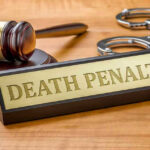 Judge Keeps Death Penalty Despite Prosecutor Contempt Gavel, handcuffs, and Death Penalty sign on desk.