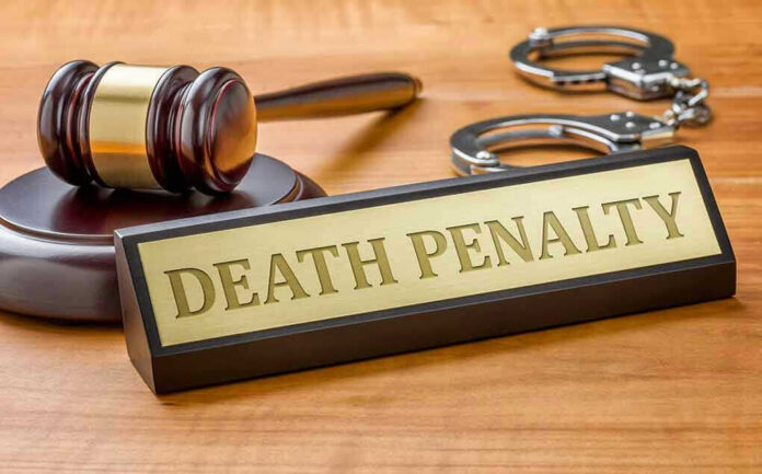 Gavel, handcuffs, and Death Penalty sign on desk.