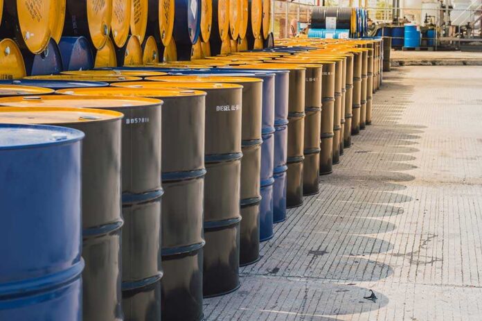 Industry,Oil,Barrels,Or,Chemical,Drums,Stacked,Up.chemical,Tank.container,Of Rows of oil barrels in a storage facility
