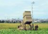 Strait Tensions Rise After Rocket Test Military defense system deployed in a field with soldiers nearby