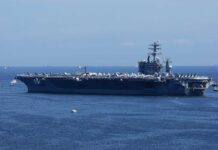 Trump Warns Iran of ‘Annihilation’ as Missiles Hit U.S. Bases A large aircraft carrier sailing in the ocean