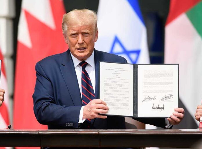 shutterstock_1816392461 A man holding a signed document during a diplomatic event
