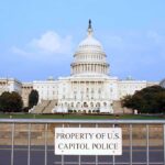 Congress Rebels: Trump War Powers Showdown View of the U.S. Capitol building with a security barrier in front