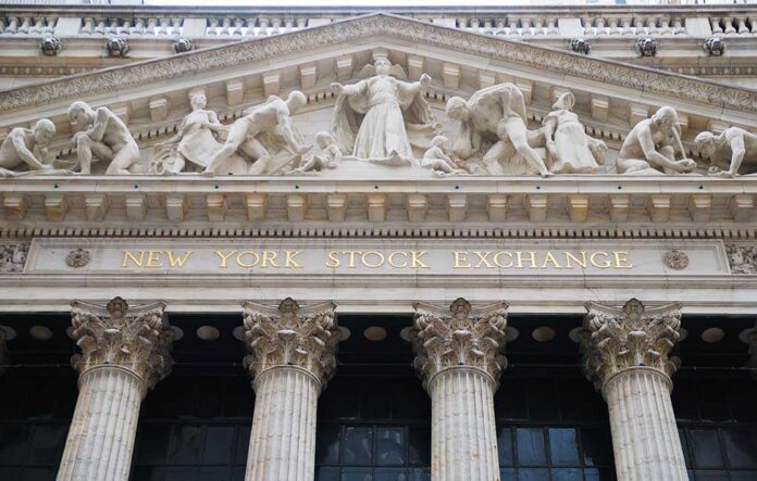 Facade of the New York Stock Exchange featuring classical columns and sculptures