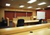 Surveillance Shows Freezer Move After Woman Vanishes Interior view of an empty courtroom with wooden furniture and American flags