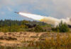 South Korea’s Rocket System Stuns the West Military tank firing a missile in forest area.