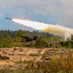 Military tank firing a missile in forest area.