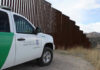 Court Records and Family Claims Raise Border protection vehicle near a large metal fence.