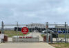 Fresh Intelligence Report Fuels Concerns Chain-link fence with Restricted Area Stop No Photography sign.
