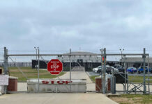Fresh Intelligence Report Fuels Concerns Chain-link fence with Restricted Area Stop No Photography sign.