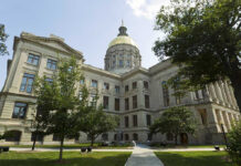 Wisconsin Governor Race Erupts Over Taxpayer Historic building with a gold dome and surrounding trees.