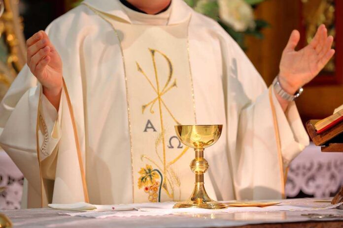 Priest,Celebrate,Mass,At,The,Church,And,Empty,Place,For A priest performing a religious ceremony with a golden chalice