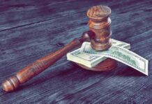 Gruesome Bank Shock: Rooftop Arrest, Quick Release Judge's gavel resting on a stack of US dollar bills