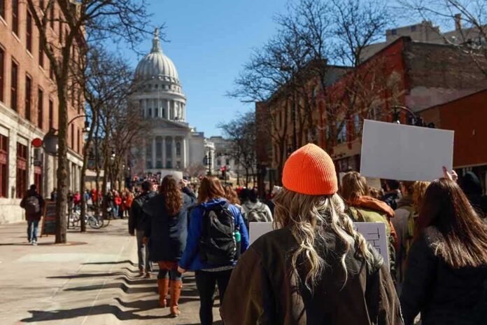 Crowd of protesters walking toward a domed capitol building