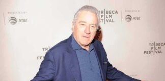 man in blue blazer posing at a film festival step-and-repeat