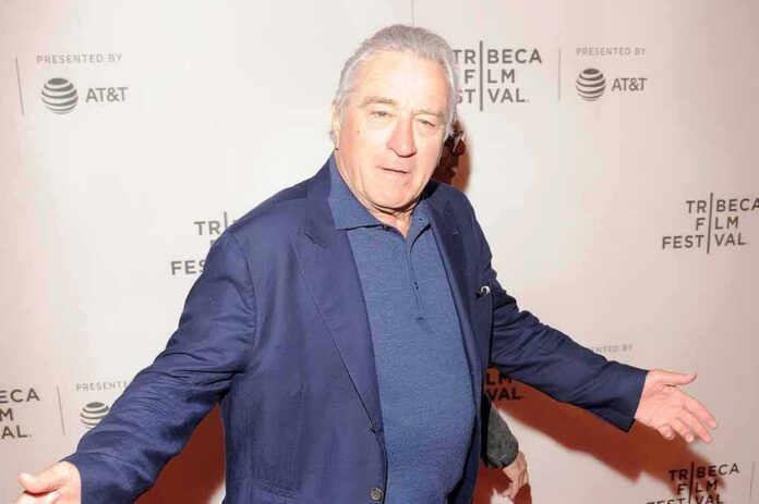 shutterstock_1079811758 man in blue blazer posing at a film festival step-and-repeat