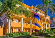 Vacation Turned Tragic: Family Seeks Answers After Death Colorful resort building surrounded by palm trees and lush greenery