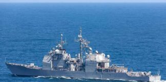 Gray naval warship cruising on open sea