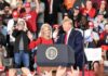 political rally with two speakers at a podium