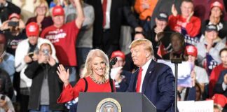 political rally with two speakers at a podium