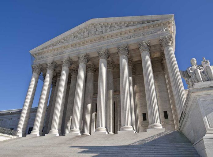 The,Supreme,Court,Building,In,Washington,Dc. The Supreme Court building featuring grand columns and statues under a clear blue sky