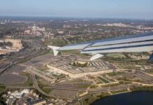 airplane wing over a sprawling government complex