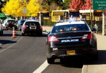 3 Illegal Immigrants Arrested, Then Released on Bond Police cars with lights on near school buses on a city street
