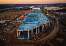 aerial view of large industrial building under construction at sunset