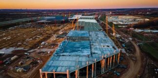 aerial view of large industrial building under construction at sunset