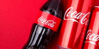 Coca-Cola bottle and cans on a red background