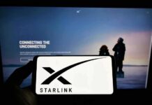 Starlink Aims to Replace Cell Carriers Smartphone showing Starlink logo in front of a computer screen