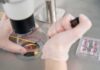 Stanford’s Lab Viruses? AI Did It Gloved hands manipulating samples under a microscope in a petri dish