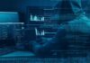 Hooded person at multiple computer screens with code and charts