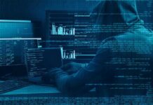 FBI Alarm: AI Is Supercharging Online Scams Hooded person at multiple computer screens with code and charts