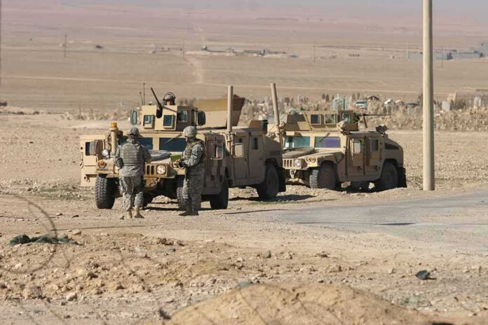 shutterstock_76580419 Soldiers near armored vehicles in a desert