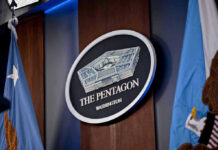 Pentagon Purge Silences Military Newspaper The Pentagon emblem between two flags.