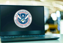 Schools and Airports Feel TPS Fallout Laptop displaying U.S. Department of Homeland Security logo.