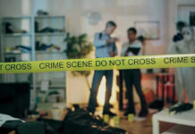 Restaurant Co-Owner Dies at 41 in Greece Crime scene with tape and investigators examining evidence.