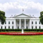 White House Pushes National AI Rules The White House with fountain and red flower bed