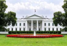 White House Pushes National AI Rules The White House with fountain and red flower bed