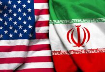 U.S.-Iran Talks Face a Hormuz Test United States and Iran flags side by side