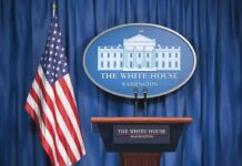 Trump Threatens Force if Oman Restricts Hormuz White House press briefing podium and US flag