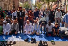 Paris ERUPTS: Mass Draws Massive Crowd Group of people praying outdoors on a city street