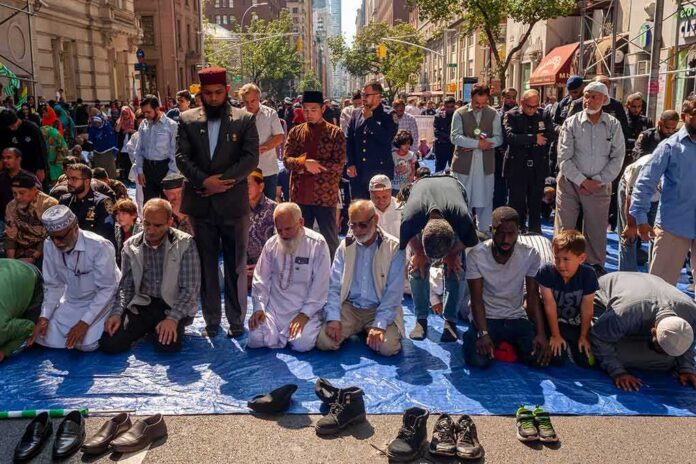 Group of people praying outdoors on a city street
