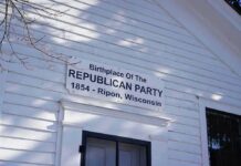 Wisconsin GOP Eyes Governor’s Seat White clapboard building facade with a historical sign above a doorway