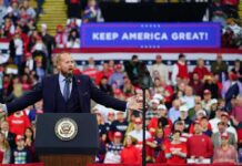 Vance Frames Midterms Around America’s “National Birthright” Crowd at a political rally with a speaker at a podium; Stephen Paea, Curtis Lofton, Walter Jones, John Sullivan, and Colin David Jones present