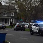 Mystery Nude Rider Dodges Police Again Police SUVs with lights on block a suburban street